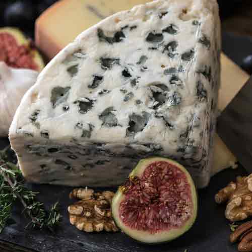 a slice of roquefort cheese on a table